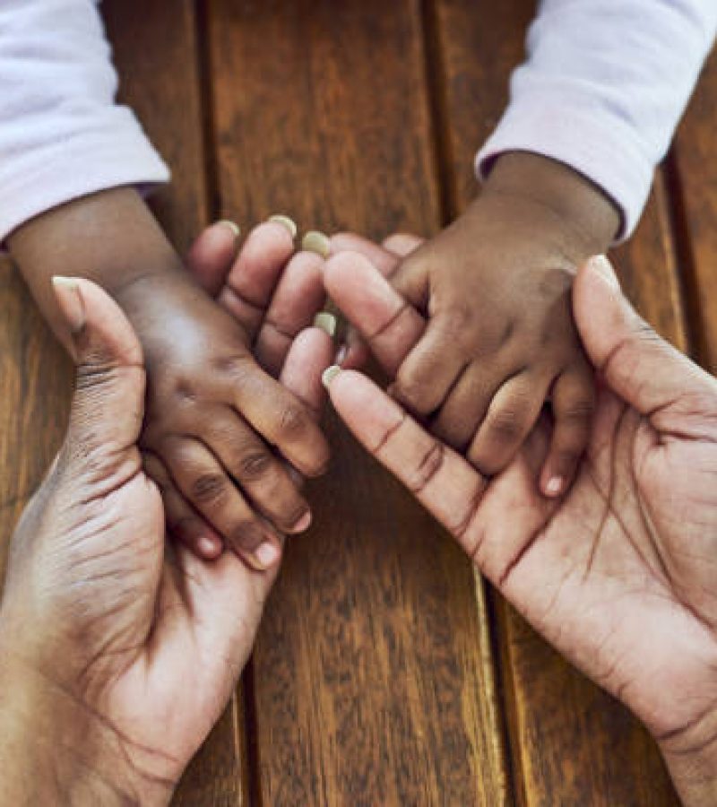 Closeup shot of a mother holding hands with her little daughter Closeup shot of a mother holding hands with her little daughter